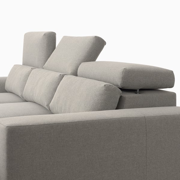 A gray ISTABY sofa with adjustable headrests for comfort, and space under the seats for storage.