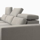 A gray ISTABY sofa with adjustable headrests for comfort, and space under the seats for storage.