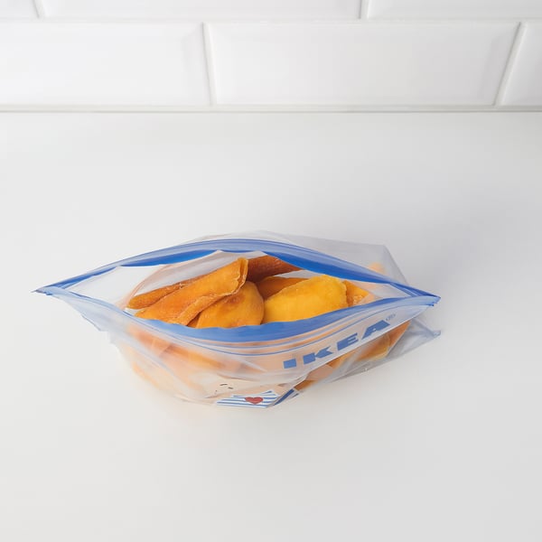 Blue IKEA resealable bag of frozen food on white shelf.