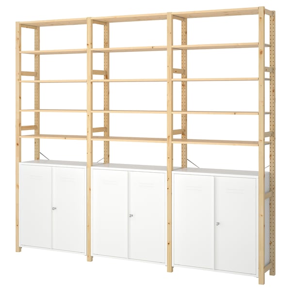 An IVAR wooden shelf and cabinet unit. It natural pine shelves and white metal cabinets. The design is modern and customizable.