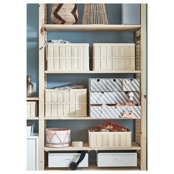 Blue wooden storage shelves with light wooden crates, striped boxes, and decorative baskets.