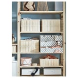 Blue wooden storage shelves with light wooden crates, striped boxes, and decorative baskets.