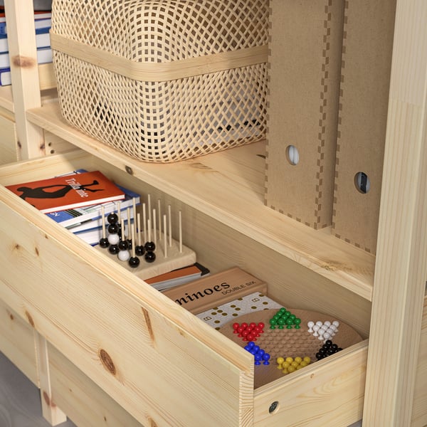 Wooden bookshelf with adjustable shelves, holding books and colorful game pieces in drawers.