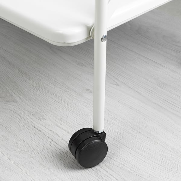 Close-up of sturdy metal table leg with black castor wheel, showcasing quality and mobility.