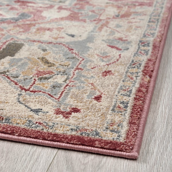 Soft, durable rug with classic oriental patterns and pastel colors on a light wooden floor.