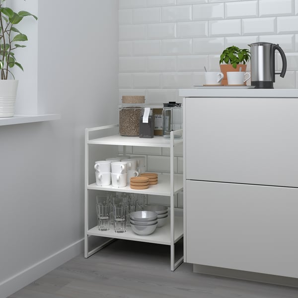 Small JONAXEL white metal shelf, neatly organizing kitchen items.