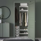 Green closet with JONAXEL storage, shelves, hanging bars, small cabinet, mirror, plant.