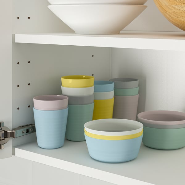 Colorful kids bowls and cups stack neatly for space-saving storage, ideal for learning to eat independently.