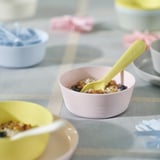 KALAS bowls in pink and pastel colors, made of durable plastic, round shape with a yellow spoon, small size, perfect for kids.