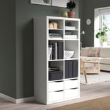 White KALLAX shelf with books, decor, and storage in living room.