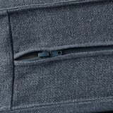 Close-up of durable, textured KIVIK sofa fabric, showcasing quality zipper detail.