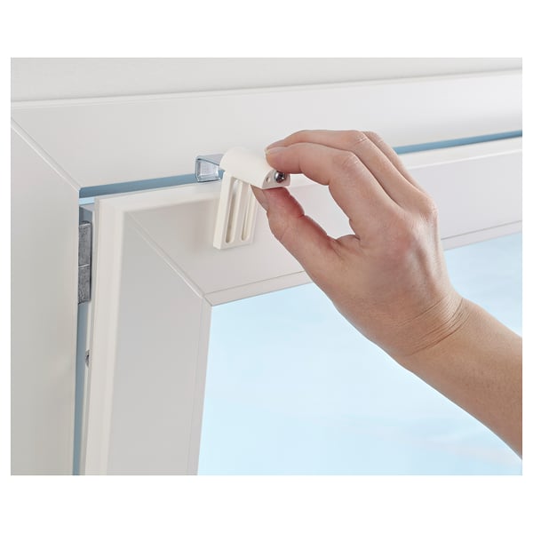 Attaching KLAMBY blind mount to window frame.