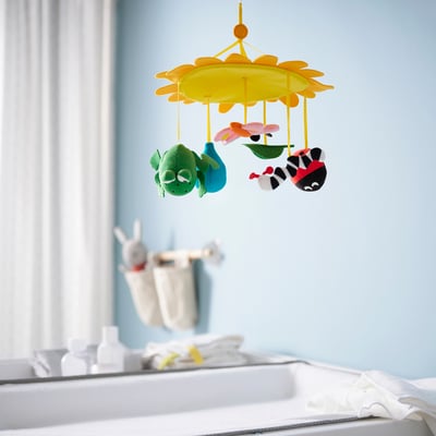Yellow baby mobile with frog & bee for visual stimulation.
