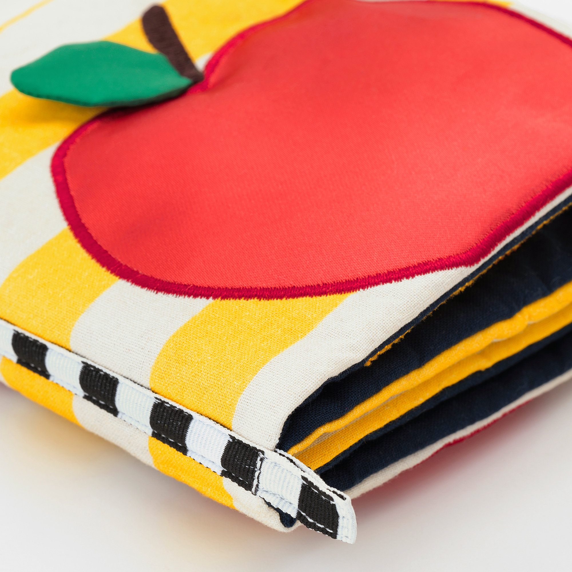 Bright, plush baby play book with colorful apple design, soft yellow and black stripes, perfect for little hands.