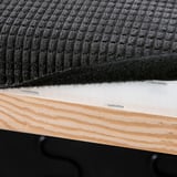 Close-up of sofa cushion attachment. Hook-and-loop fasteners secure the cover to wooden base.