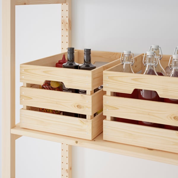 Wooden storage crates on shelves holding bottles and cans, showcasing organized storage for kitchen or garage.