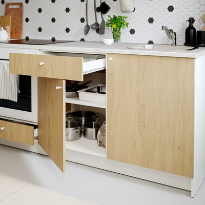 White KNOXHULT kitchen base unit with light wood doors and marble worktop.