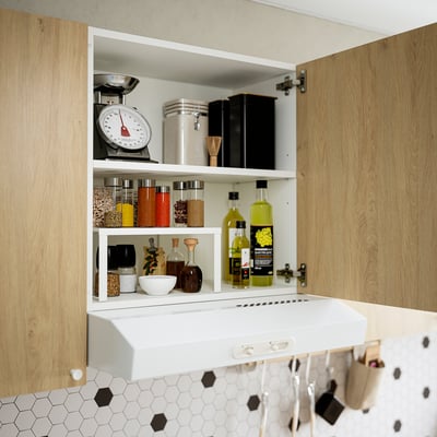 Kitchen cabinet open, showing organized storage with spices, bottles, kitchen tools, and an adjustable shelf.