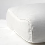 Close-up of plush, white pillow with smooth fabric and neatly stitched seams, showcasing high-quality craftsmanship.