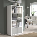 White KOSINGEN storage box in kallax unit, holding books & decor, fits neatly in corner, blending with modern room decor.