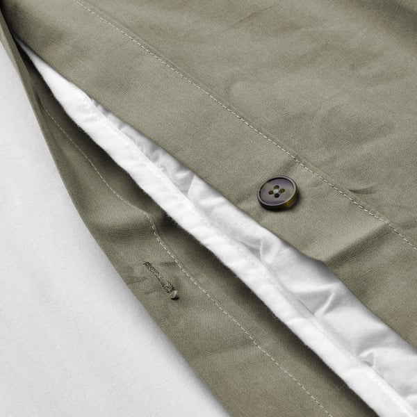 Close-up of green duvet cover with button, showing soft fabric and moisture-absorbing cotton/viscose blend.