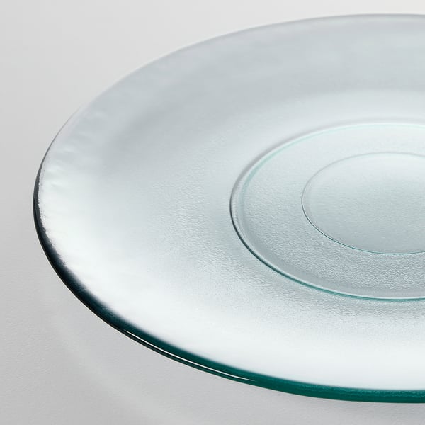 Round glass plate with smooth, slightly textured surface, made from recycled glass. High-quality and eco-friendly.