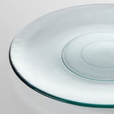 Round glass plate with smooth, slightly textured surface, made from recycled glass. High-quality and eco-friendly.