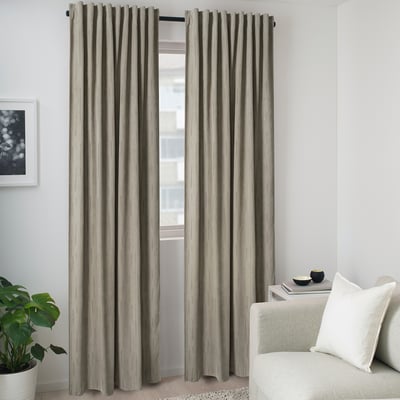 Beige recycled polyester curtains beside white couch, plant & art.
