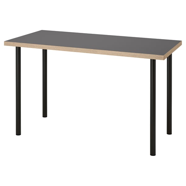 An ikea LAGKAPTEN desk with a grey top and black metal legs. Its rectangular, modern, and minimalist in design.