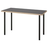 An ikea LAGKAPTEN desk with a grey top and black metal legs. Its rectangular, modern, and minimalist in design.