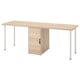 An LAGKAPTEN desk in light oak color with a storage cabinet. It a wooden top and white metal legs. The cabinet has a single door for storage.