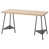 A LAGKAPTEN desk with a light wooden top and black metal legs, featuring a minimalist and modern design with triangular bases.