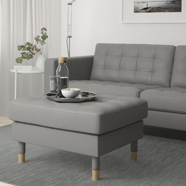 Grey LANDSKRONA footstool with leather & fabric, adds extra seating in modern living room.