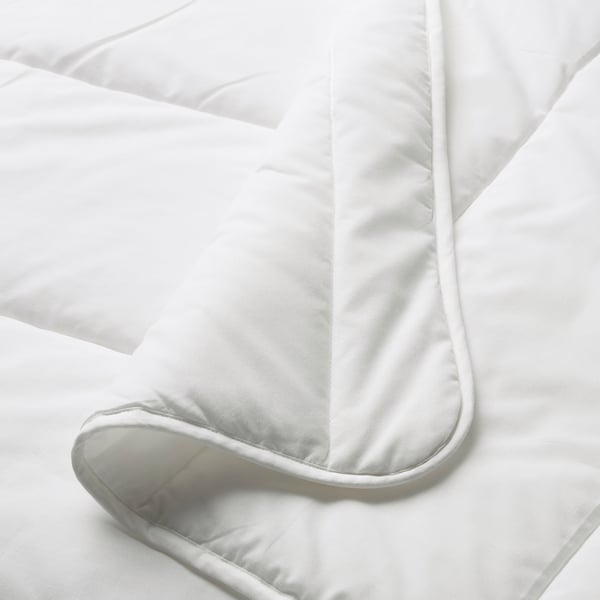 Close-up of white duvet, smooth texture, neatly folded, showcasing stitching detail.