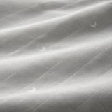 Soft, wrinkled muslin fabric close-up, showcasing its smooth texture and quality.