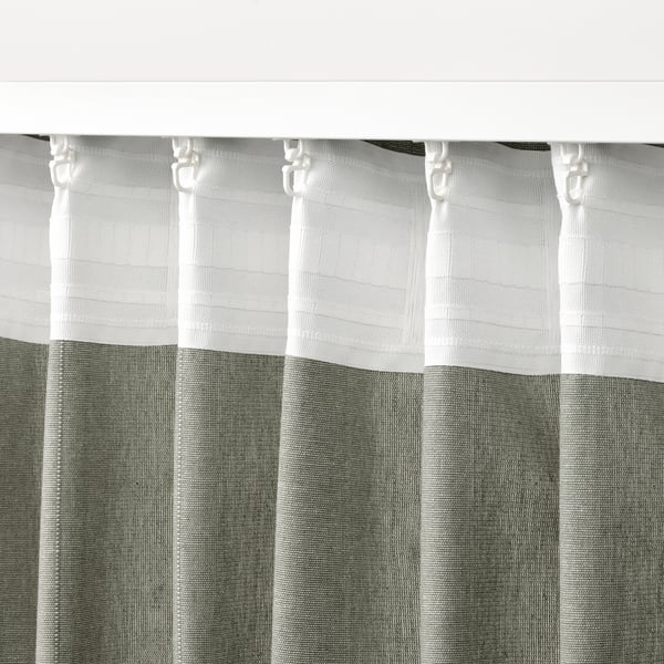 Curtains with header tape, hooks visible, offering privacy and light filtration.