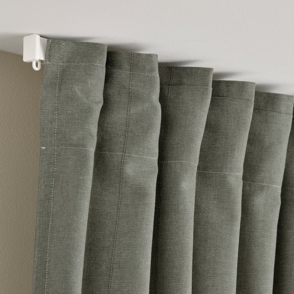 Gray-green LENDA curtains with header tape hang neatly, allowing for adjustable folds and privacy.