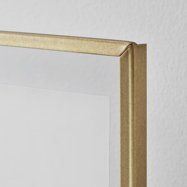 Gold-framed photo display with a sleek, clear lacquered and steel edge.