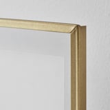 Gold-framed photo display with a sleek, clear lacquered and steel edge.