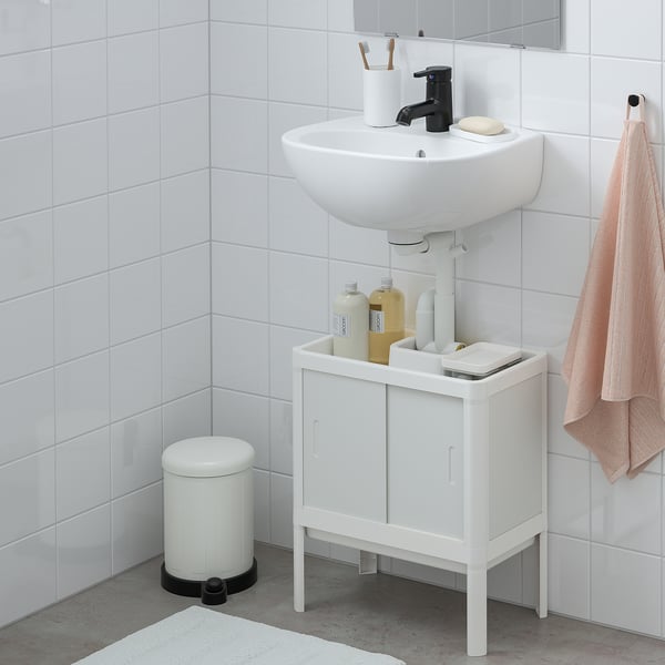 Modern compact bathroom with white LILLTJÄRN cabinet, round basin, black faucet, and towel rack.