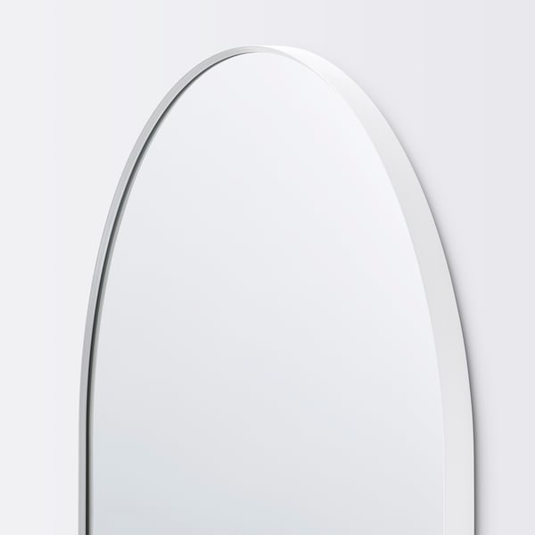 Arch-shaped mirror with sleek, white frame; reflective surface pristine, corners rounded; minimalist, elegant design.
