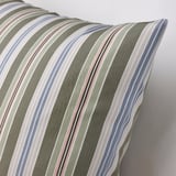 Striped throw pillow with mixed material, showing quality recycled fabric in green, blue, and white stripes.