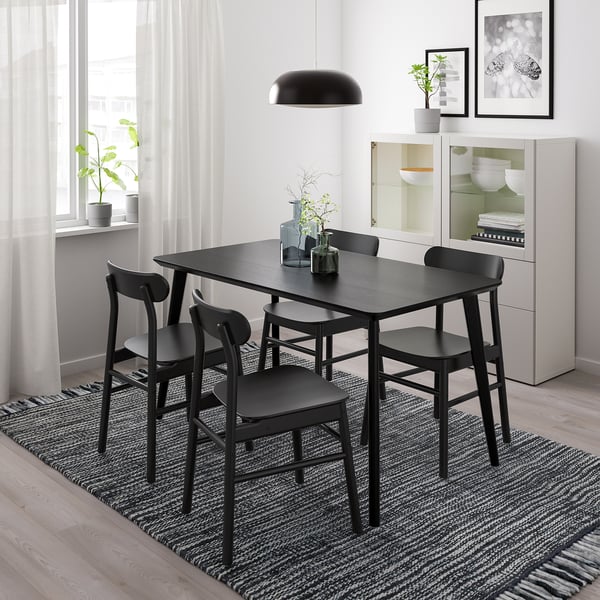 Black LISABO dining set with rectangular table and four chairs, minimalist white room.