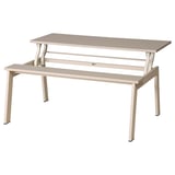 A LJUNGSBRO multi-functional table in beige. It a rectangular top, metal legs, and a lifting mechanism.