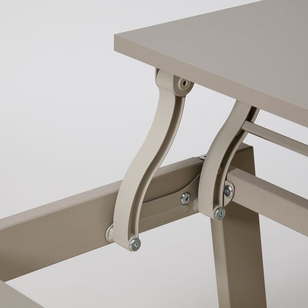 Close-up of sturdy metal table leg with adjustable bolts, supporting a smooth table top.