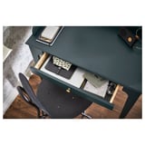 Green LOMMARP desk with open drawer showing items inside. Dark chair, clean workspace.