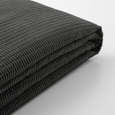 Close-up of soft, textured black fabric, folded. High-quality, recycled materials.