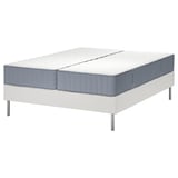 An IKEA LYNGÖR bed with a white base and grey mattress, featuring edge-to-edge pocket springs for support and comfort.