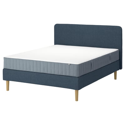 Blue LYNGÖR bed with grey mattress, wooden legs, and headboard; stylish and cosy.