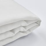 A close-up of a crisp, white, textured fabric, neatly folded, showcasing high-quality material and precise stitching.